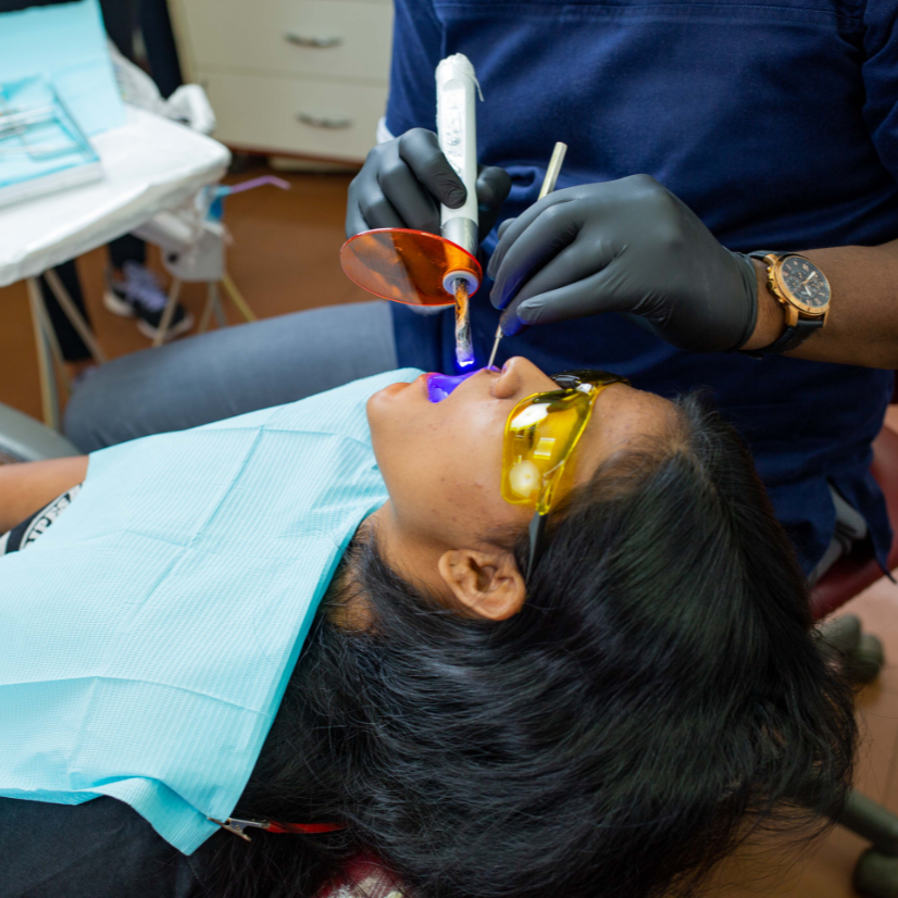 dentist with patient in dental chair